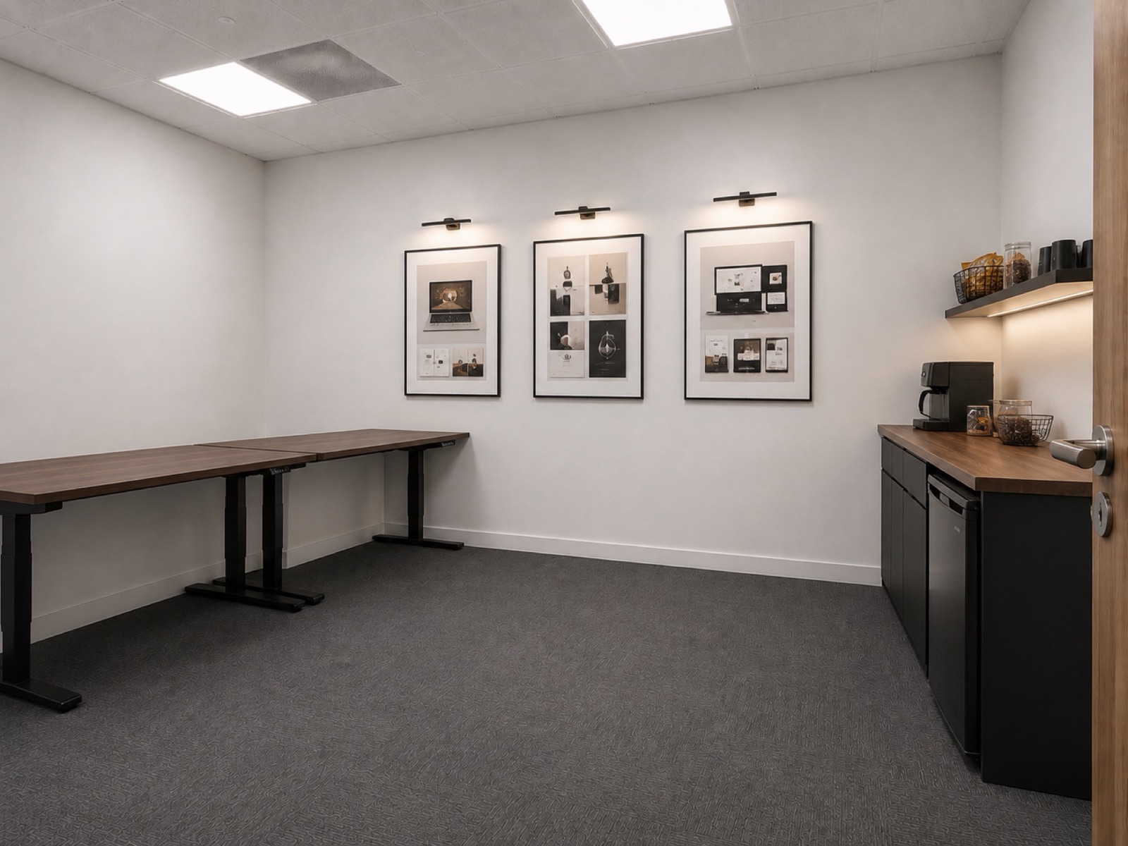 A quiet studio space with framed website designs on the wall